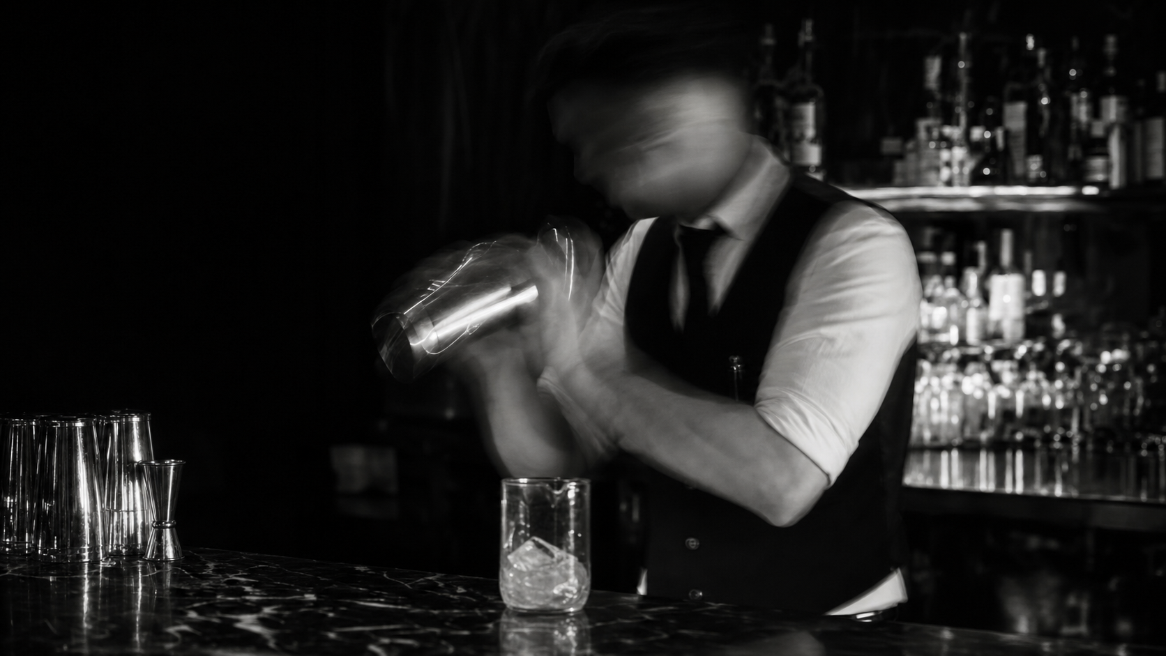 Roko mixing a cocktail behind the bar